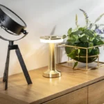 Gold cordless table lamp placed on a sideboard as decor